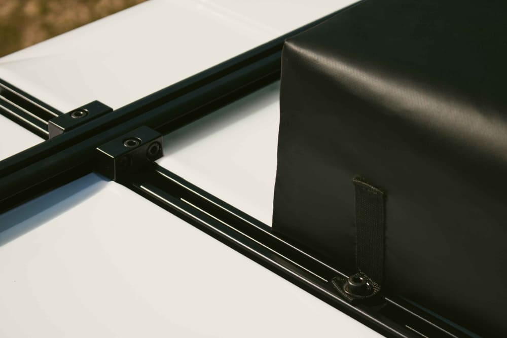 Close-up of the integrated roof rack crossbars on the hard shell, designed to carry heavy loads like kayaks or bikes.