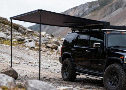 Side profile view of the deployed auto-roll car awning, showing the sturdy aluminum legs and full extension range.