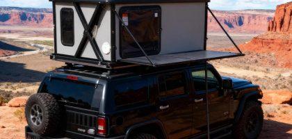 Electric automatic hard shell roof top tent with remote control setup, featuring aluminum casing and instant deployment.