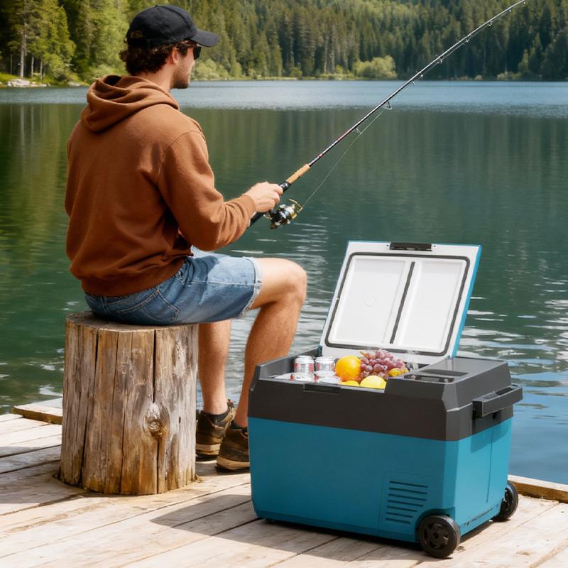F2 Dual-Battery Portable Fridge (29L) | Hybrid Power Freezer with Tool Battery Support 5 Scene of a man fishing by a lake with the F2 dual-power portable fridge nearby, showcasing its utility for keeping catch or bait fresh during long fishing trips.