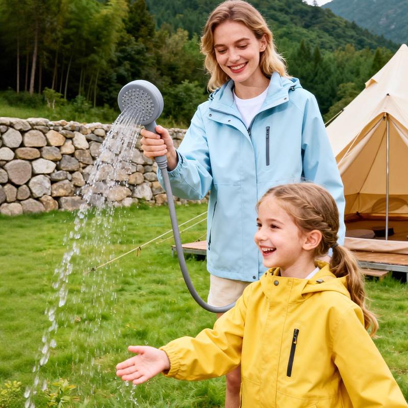 GWH-1 Thermostatic Portable Gas Water Heater | 6L Smart Camping Shower with Built-in Hose Storage 2 A young mother uses the GWH-1 thermostatic gas water heater to safely wash her daughter's hands, demonstrating the stable temperature control ideal for family camping.