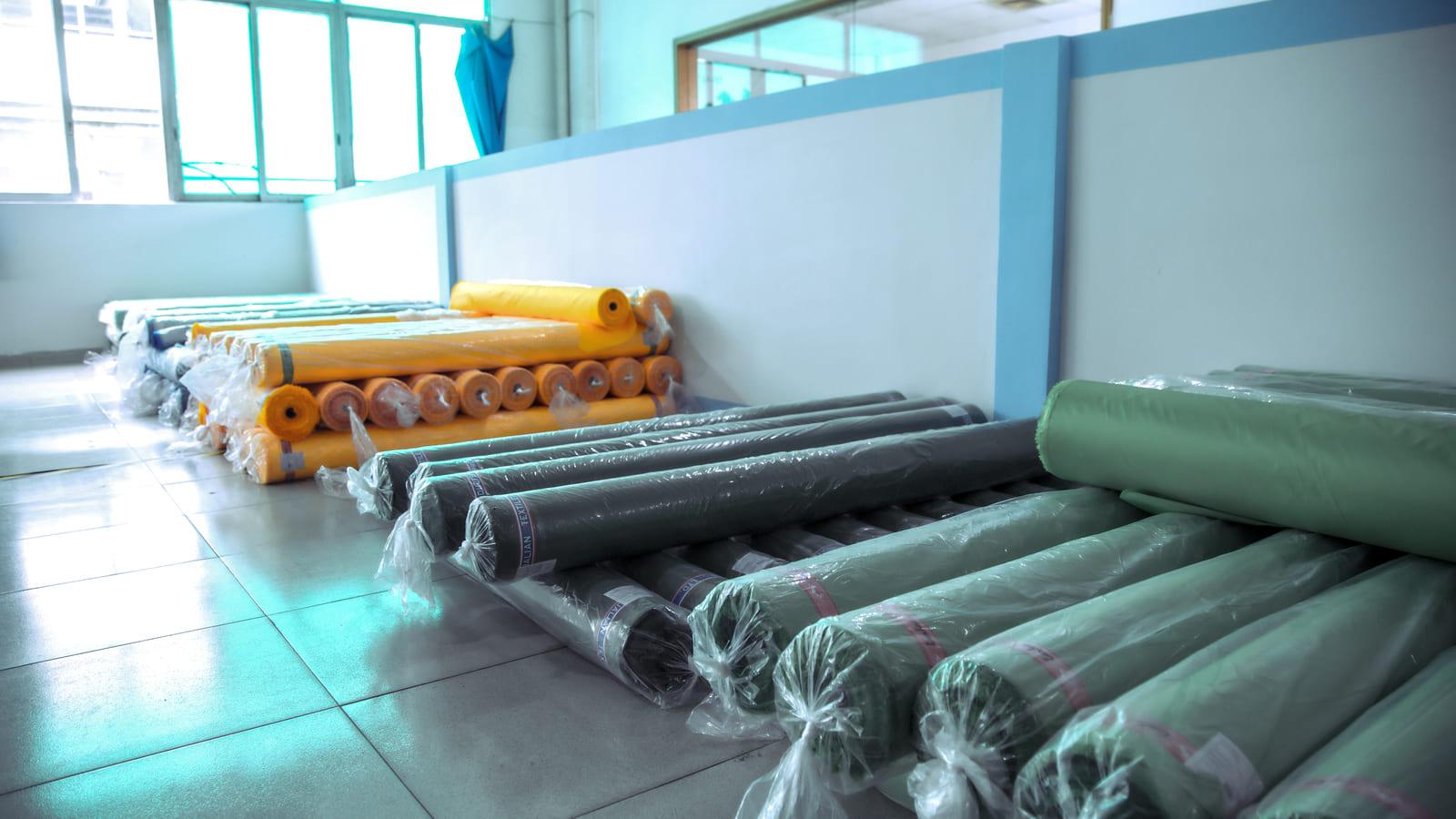 Large inventory of heavy-duty poly-cotton ripstop fabric rolls in Everlead's raw material warehouse for roof top tent manufacturing