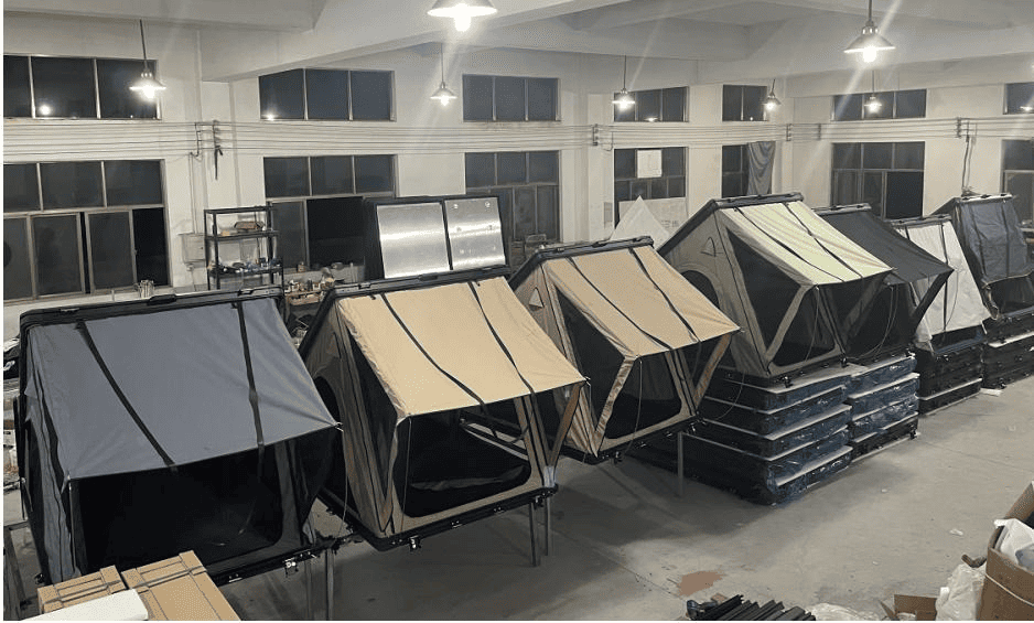 A lineup of 7 different colored A-frame rooftop tents in our factory, showcasing our diverse product range and custom color options.