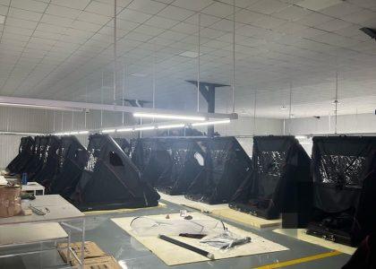 Two rows of finished clamshell triangular rooftop tents undergoing quality inspection in our direct manufacturing facility.