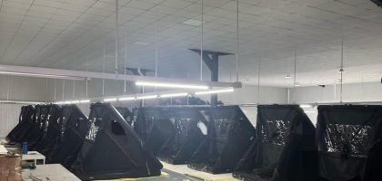 Two rows of wedge hard shell rooftop tents awaiting final quality inspection.