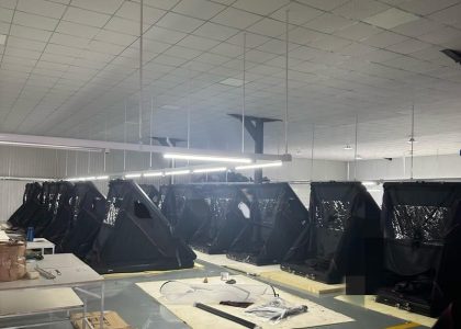 Two rows of wedge hard shell rooftop tents awaiting final quality inspection.
