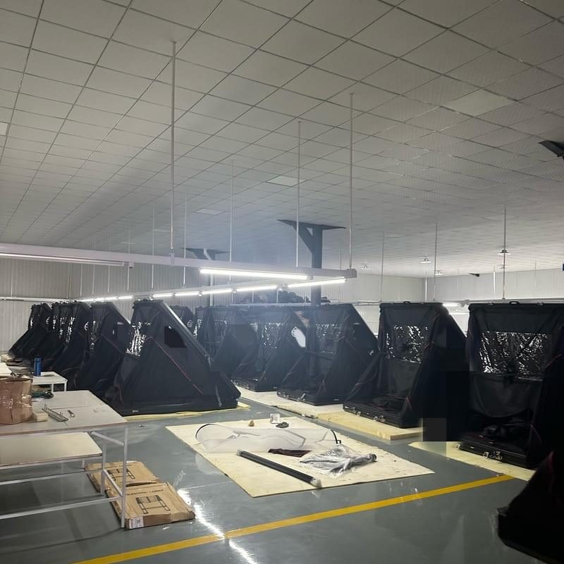 Two rows of wedge hard shell rooftop tents awaiting final quality inspection.