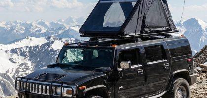 Everlead Ultra-Slim Aluminum Wedge stargazing Rooftop Tent fully deployed on a high mountain summit, overlooking a vast misty valley at sunrise. The flagship tent features a transparent panoramic roof panel designed for immersive nature viewing.
