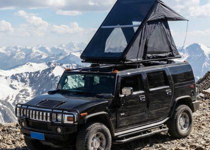 Everlead Ultra-Slim Aluminum Wedge stargazing Rooftop Tent fully deployed on a high mountain summit, overlooking a vast misty valley at sunrise. The flagship tent features a transparent panoramic roof panel designed for immersive nature viewing.