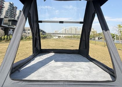 A high-end triangular hard-shell rooftop tent from the Stargazing Series, fully deployed on a 4x4 vehicle. The clear upper cover allows for an immersive, panoramic view of the night sky, ideal for stargazing.